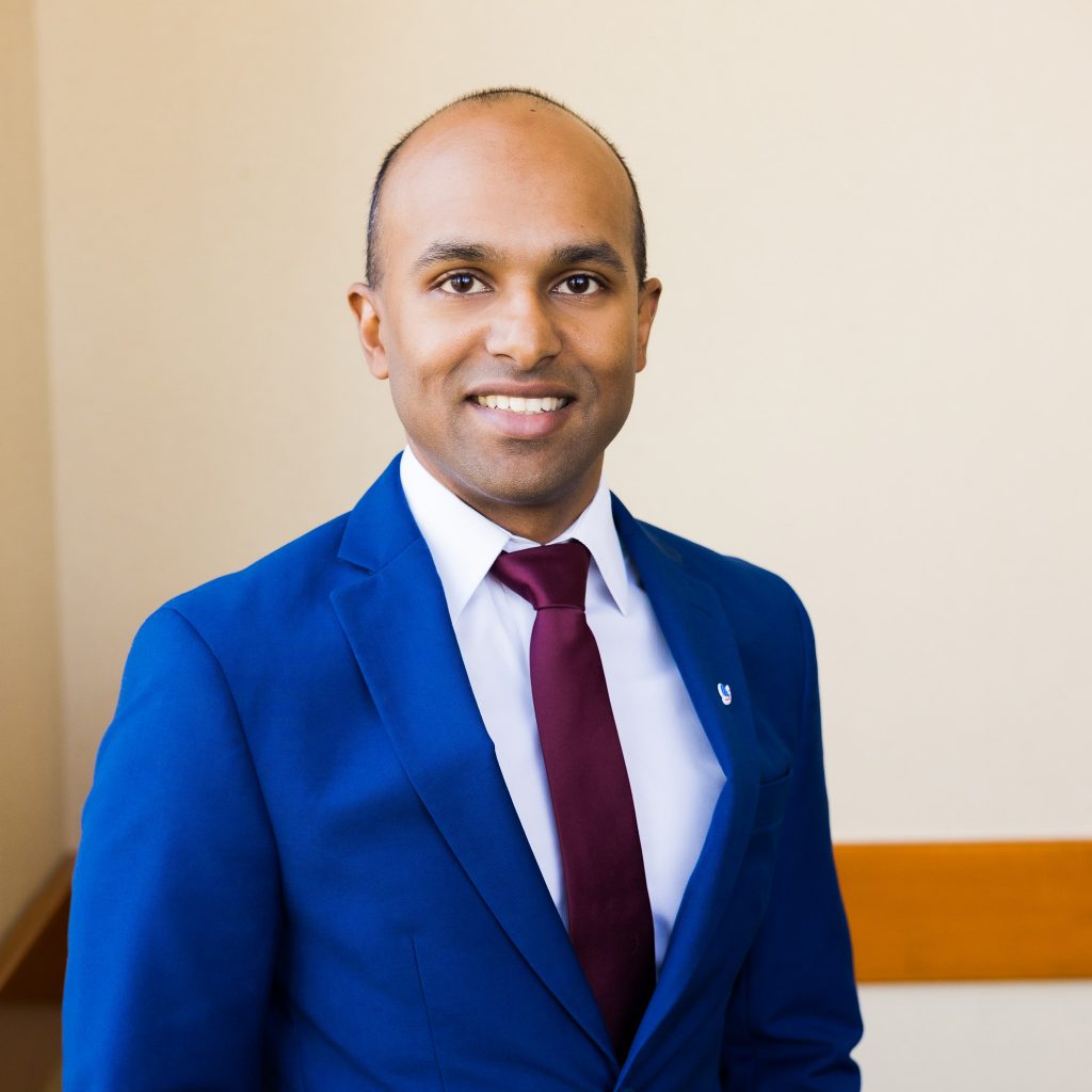 Headshot of Andrew Sewnauth Chief Executive Officer of CDS Life Transitions in a blue suit and maroon tie.